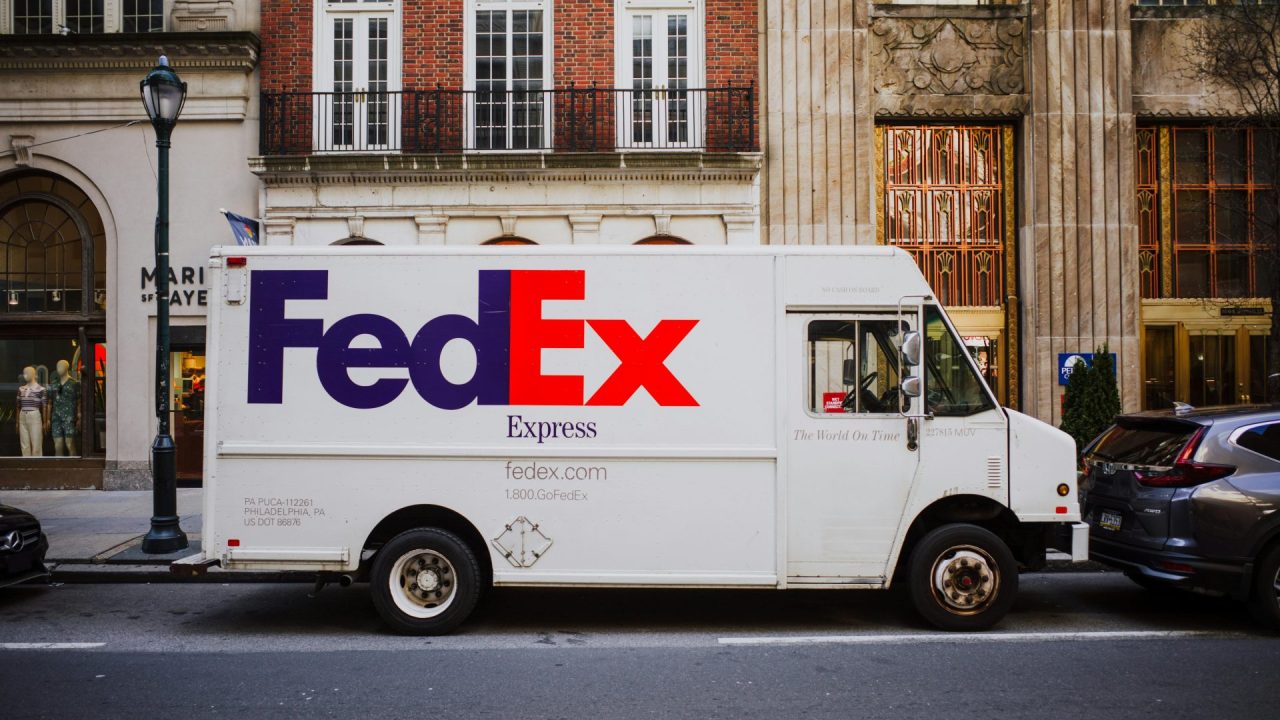White FedEx Truck on Street in City